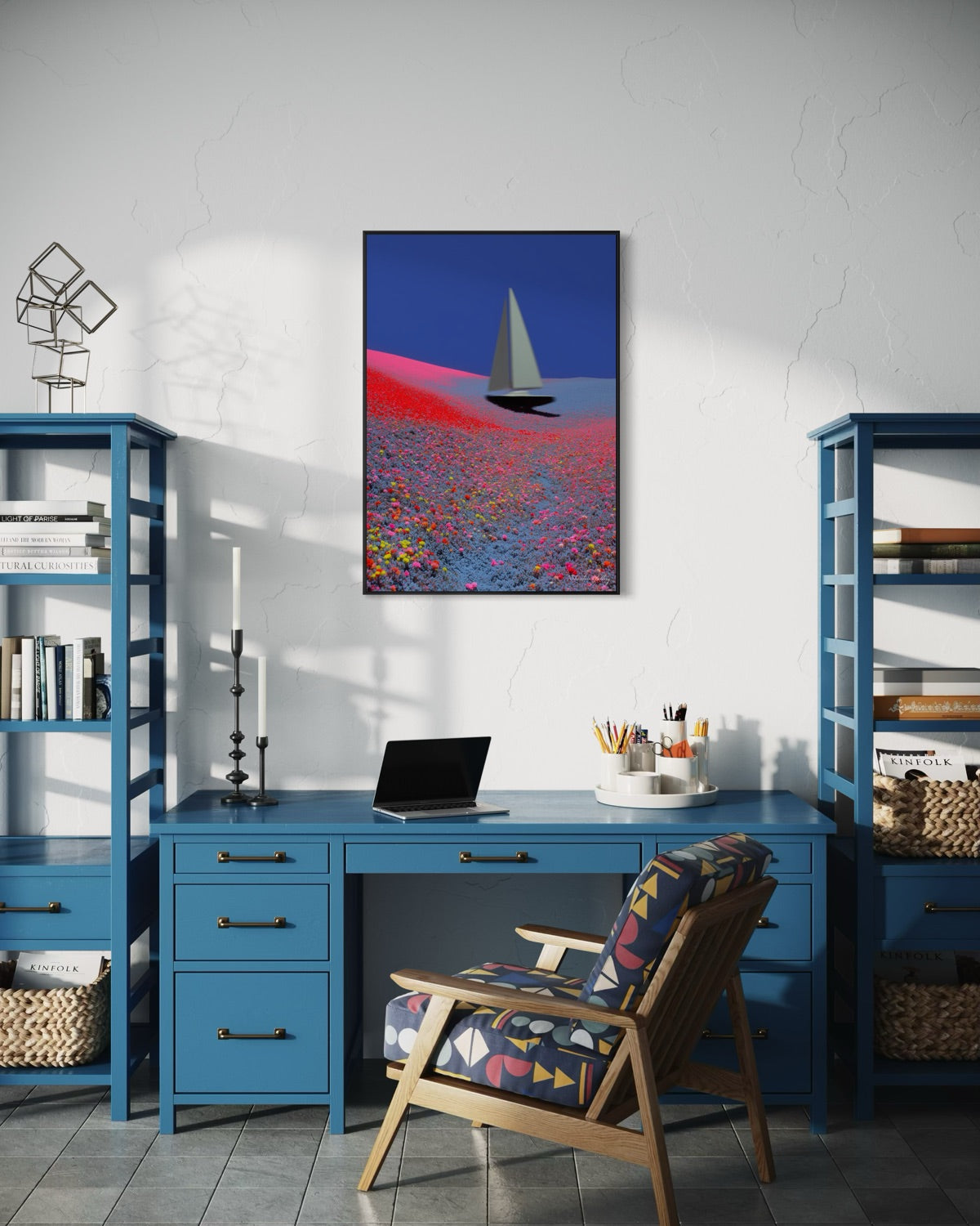 Modern home office with blue desk, chair, and shelves, featuring a colorful sailboat painting on the wall.