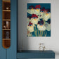 Modern interior with a blue cabinet, shelf, and abstract floral painting on a white wall.