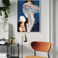 Modern interior with a framed artwork on the wall, a brown chair, and a plant.