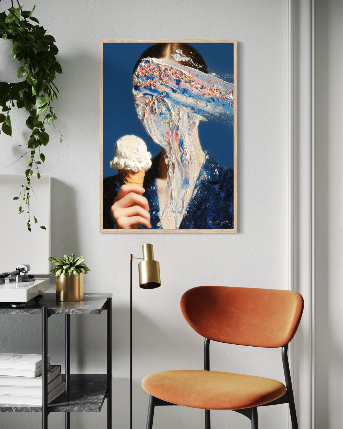 Modern interior with a framed artwork on the wall, a brown chair, and a plant.