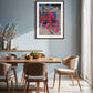 Dining room with wooden table and chairs, framed artwork on the wall.