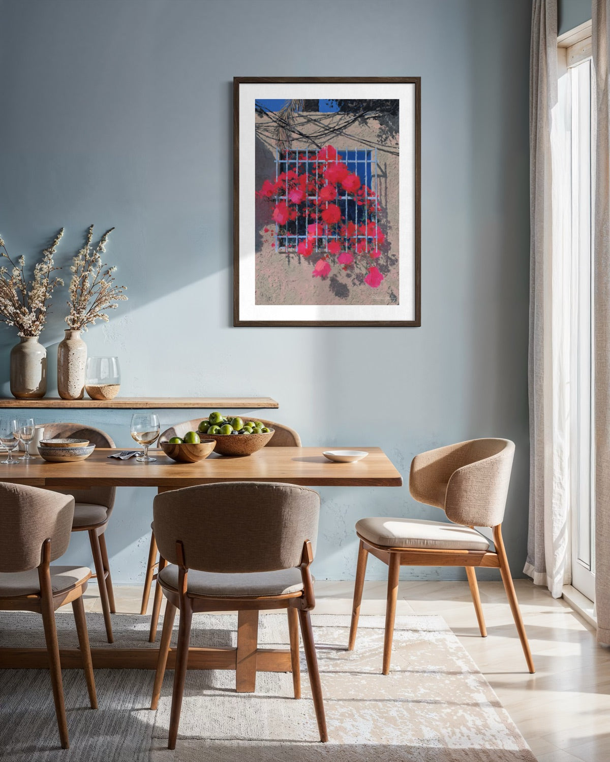 Dining room with wooden table and chairs, framed artwork on the wall.