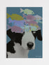 Striking contemporary surrealist collage wall art print featuring an intimate black and white portrait of a spaniel dog wearing an abstract, colorful swarm of translucent floating fish as a crown against a deep blue-grey background, titled "Symmetry of Strangers."