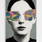 Striking surrealist collage wall art print featuring a vintage halftone dot portrait of a woman's face with colorful, textured butterfly wings covering her eyes against a muted grey background, titled "The Wings of Denial״.